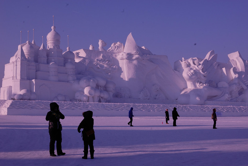 A massive snow sculpture with a full sized building